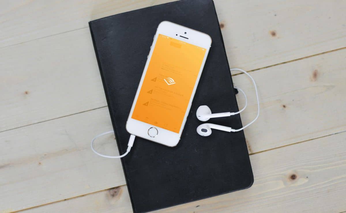 Audible Review Audible app on phone with Kindle book.