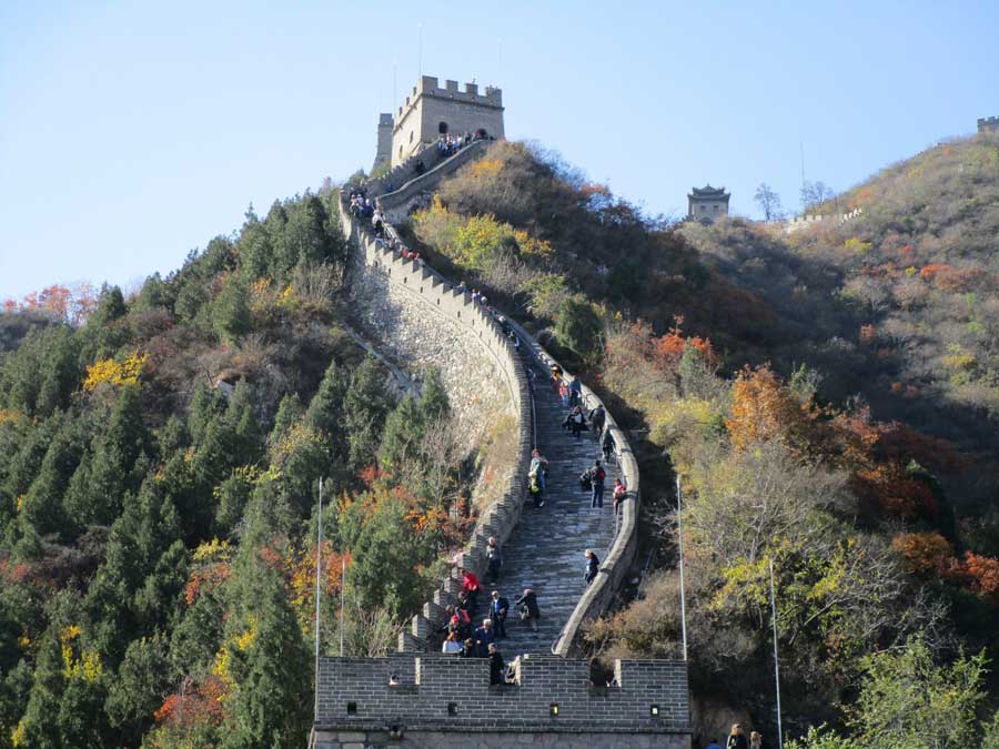 The Great Wall in autumn, with the trees starting to turn yellow and orange colors.