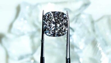 Close-up of a lab grown diamond held up by tweezers