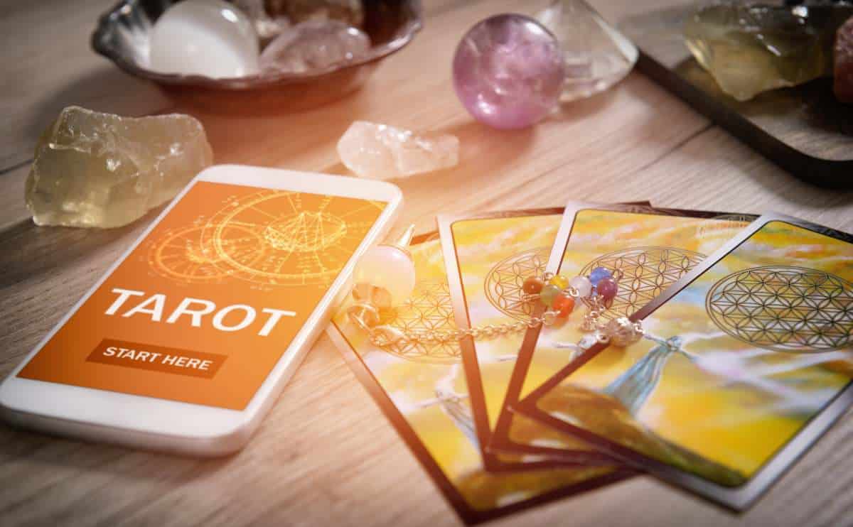 Psychic with tarot cards, phone and beads