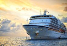 Beautiful marine view with one large cruise liner ship called Regent Navigator of Regent Seveneseas cruise line in port on sunset background.