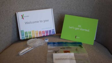 23andMe photo of unboxing - the 23andMe box and contents displayed on a chair