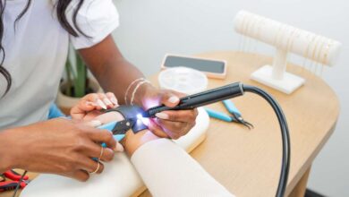 Woman welding jewelry on customer